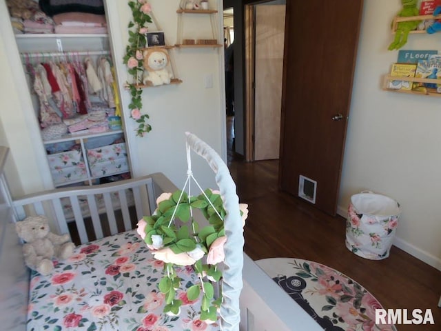 bedroom featuring wood finished floors, visible vents, and baseboards