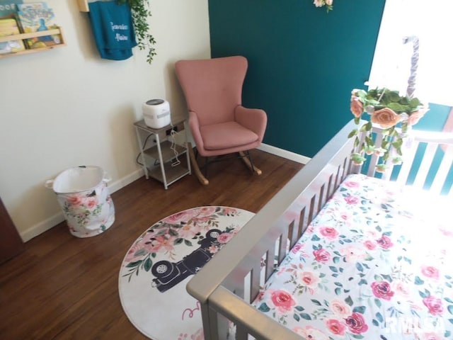 bedroom featuring wood finished floors and baseboards