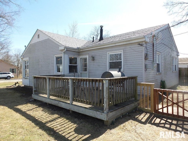 back of house with a wooden deck