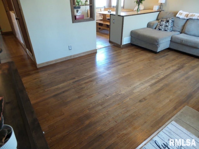 living room featuring wood finished floors and baseboards