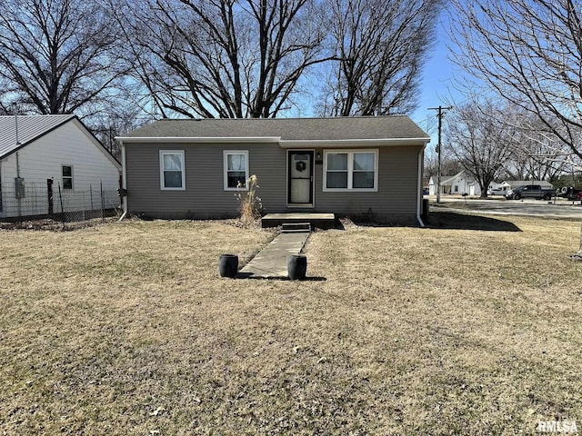 view of front of home featuring a front yard and fence