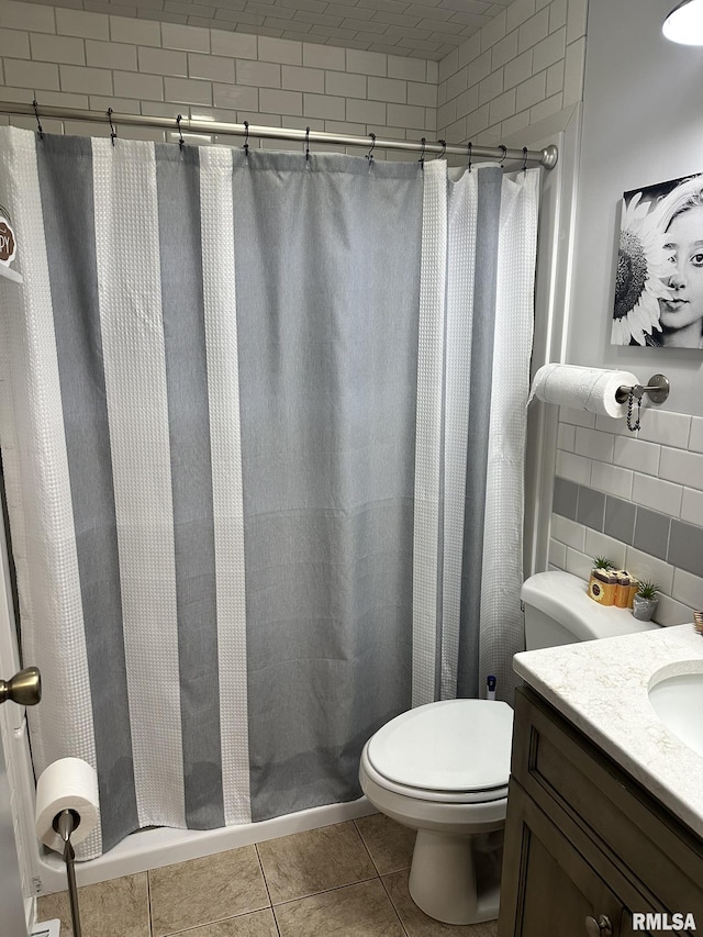 bathroom featuring a shower with shower curtain, tile patterned floors, toilet, and vanity