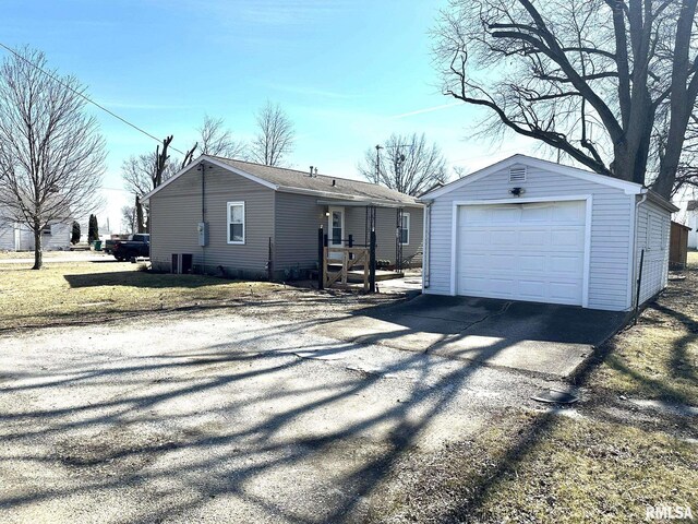 view of front of property featuring an outbuilding, driveway, and a garage