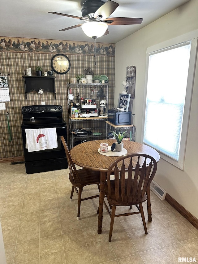 tiled dining room with visible vents, baseboards, and ceiling fan