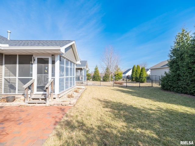 view of yard featuring fence and a sunroom