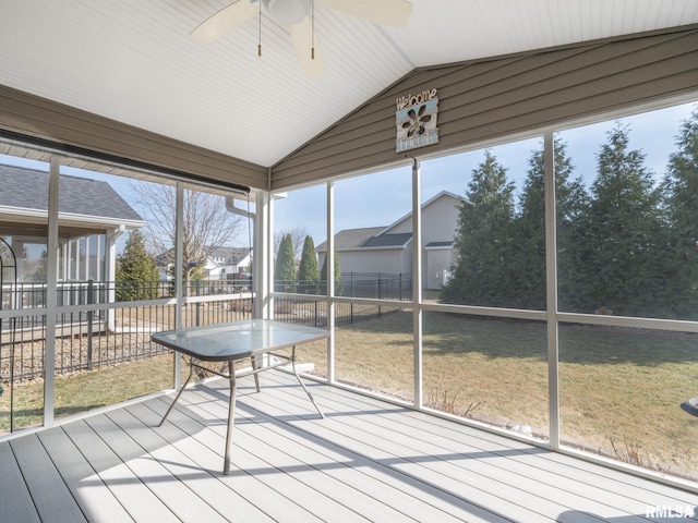 unfurnished sunroom with lofted ceiling and a ceiling fan