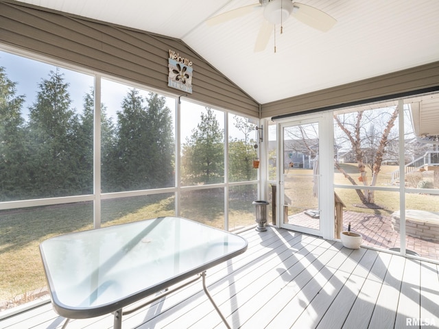 sunroom with vaulted ceiling and a ceiling fan