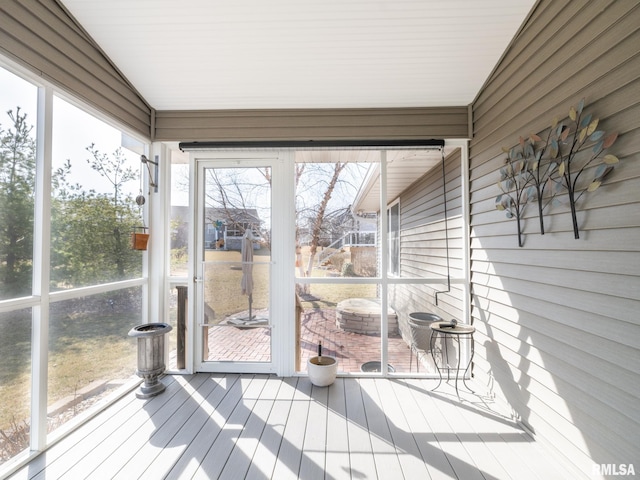 sunroom featuring vaulted ceiling