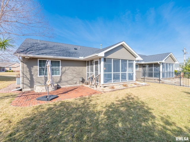 back of property featuring a patio, central AC unit, fence, a sunroom, and a lawn