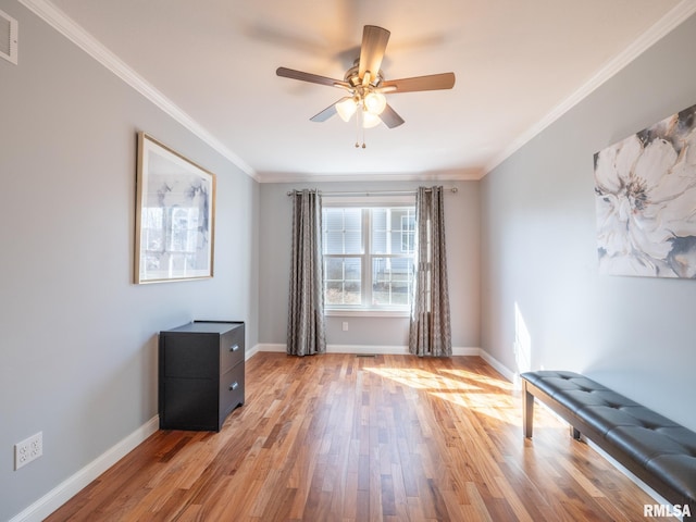 interior space with visible vents, baseboards, crown molding, and light wood finished floors