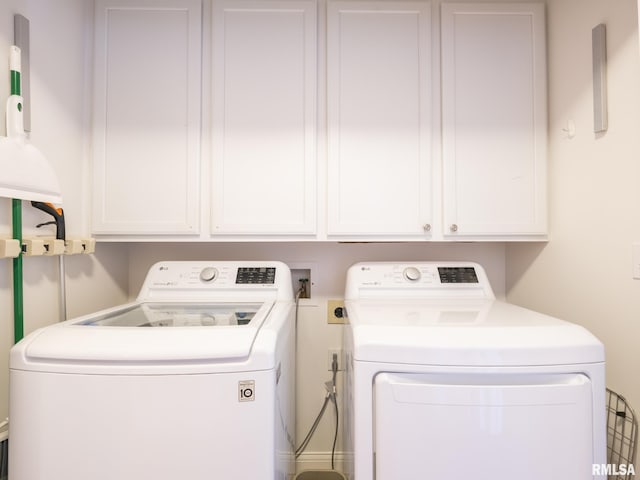 laundry area with washer and dryer and cabinet space