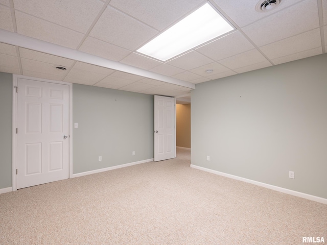 finished basement featuring a drop ceiling, visible vents, and carpet floors