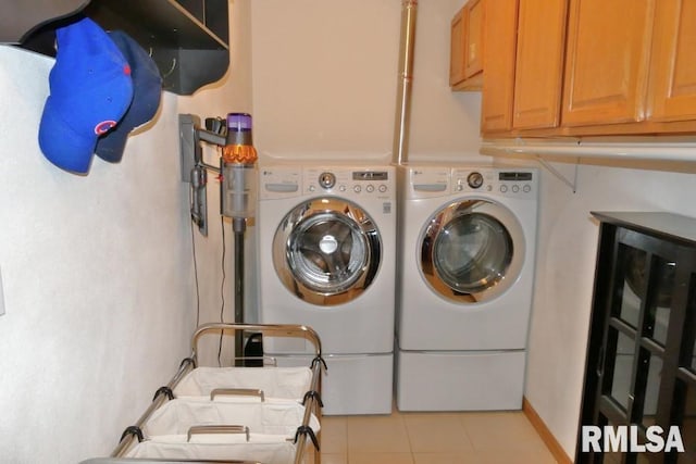 laundry area with light tile patterned floors, cabinet space, and independent washer and dryer