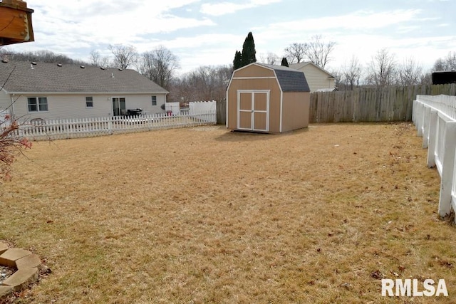 view of yard featuring a storage shed, a fenced backyard, and an outdoor structure