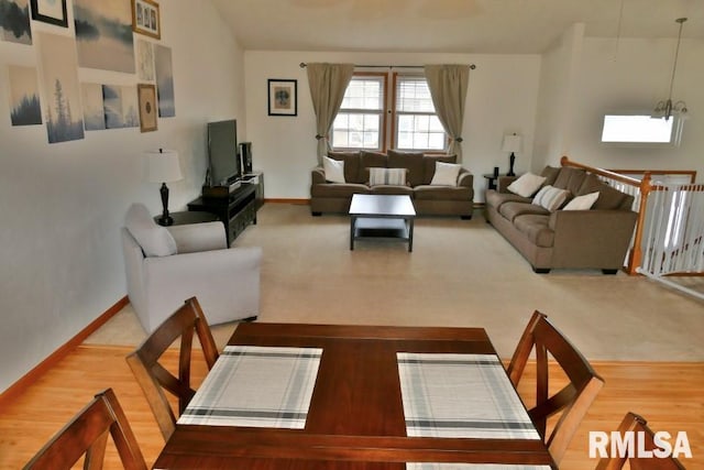 living room with baseboards and wood finished floors