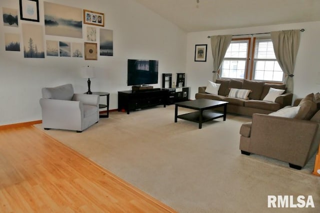 living area featuring baseboards, carpet, wood finished floors, and vaulted ceiling