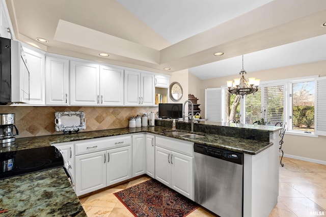 kitchen featuring backsplash, dishwasher, a peninsula, white cabinets, and a sink