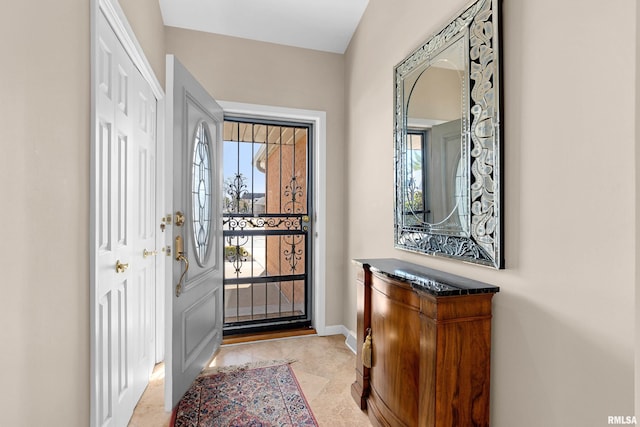 foyer featuring baseboards