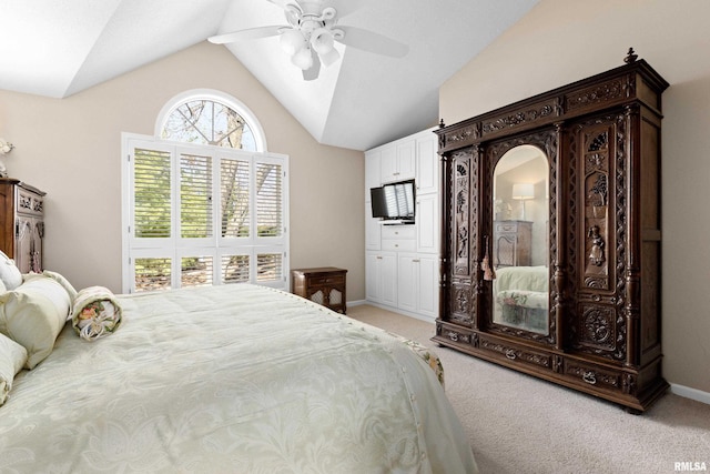 bedroom featuring light carpet, ceiling fan, baseboards, and vaulted ceiling