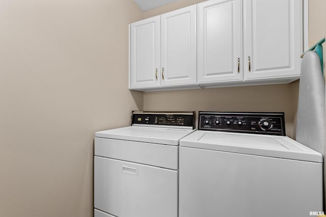 washroom featuring cabinet space and separate washer and dryer