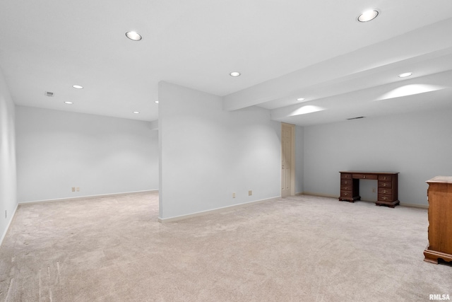 below grade area with visible vents, recessed lighting, baseboards, and light carpet