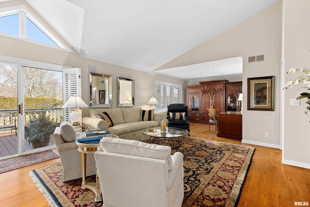 living area featuring light wood finished floors, visible vents, baseboards, recessed lighting, and high vaulted ceiling