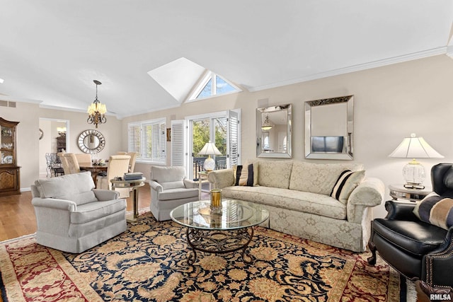 living area with vaulted ceiling, crown molding, baseboards, and wood finished floors