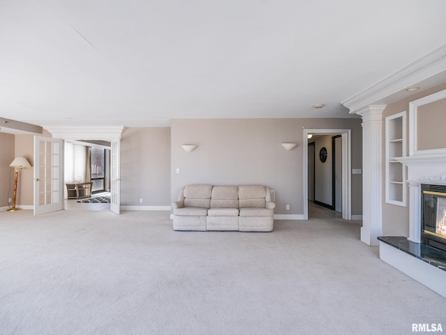 unfurnished living room featuring french doors, baseboards, carpet, and a premium fireplace