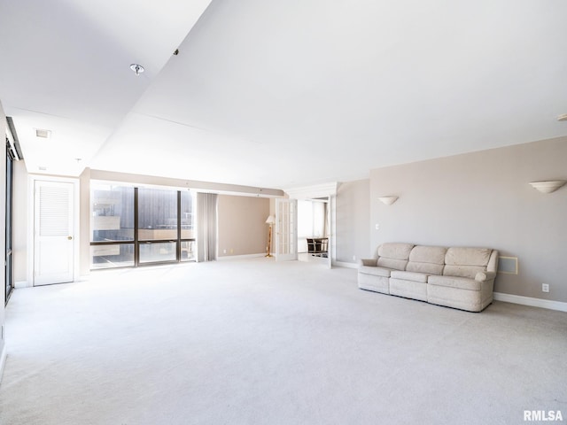 unfurnished living room with baseboards and carpet floors