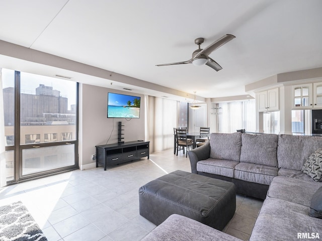 living room featuring light tile patterned floors and a ceiling fan