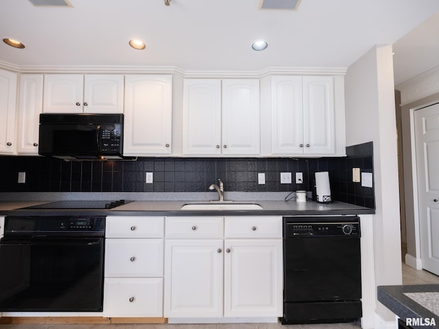 kitchen featuring a sink, dark countertops, black appliances, and white cabinets