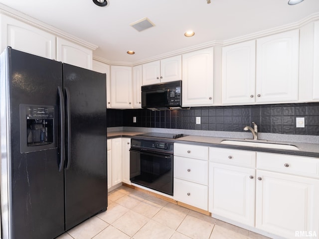 kitchen with black appliances, a sink, white cabinetry, light tile patterned floors, and decorative backsplash