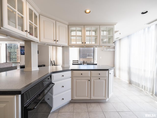 kitchen with dark countertops, visible vents, glass insert cabinets, light tile patterned floors, and recessed lighting