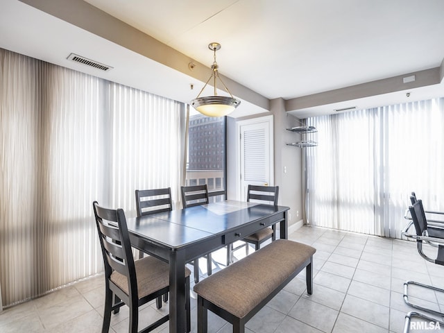 dining area with light tile patterned flooring and visible vents