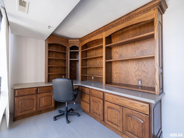 office space featuring visible vents and built in desk