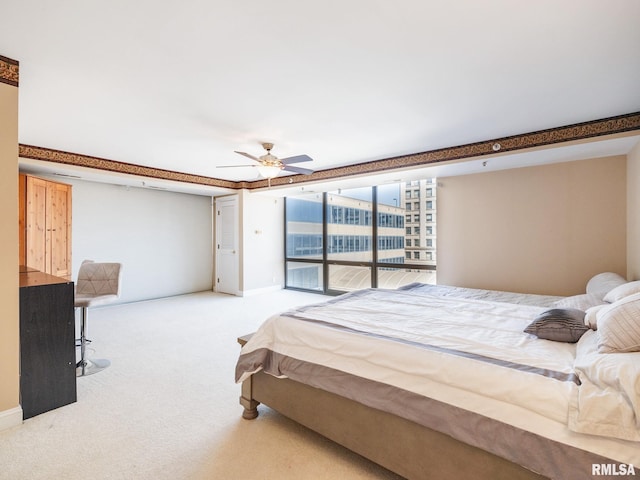 carpeted bedroom featuring a ceiling fan and baseboards