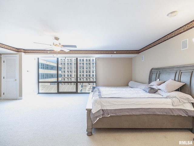 bedroom featuring visible vents, baseboards, ceiling fan, and carpet floors