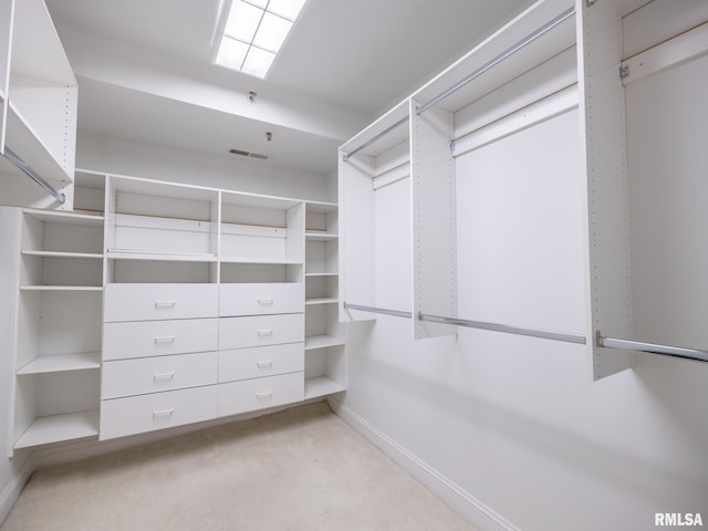 spacious closet featuring visible vents and light colored carpet