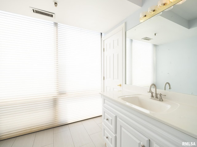 bathroom featuring tile patterned flooring, visible vents, and vanity