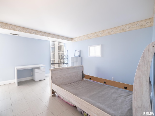 bedroom with baseboards and visible vents