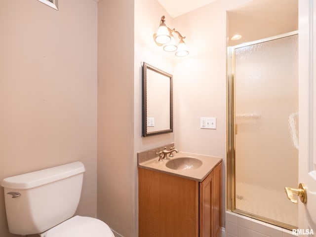 full bath featuring vanity, toilet, and a stall shower