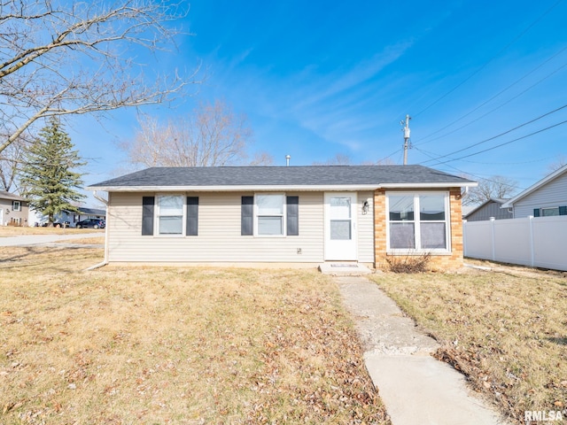 ranch-style house with a front lawn and fence