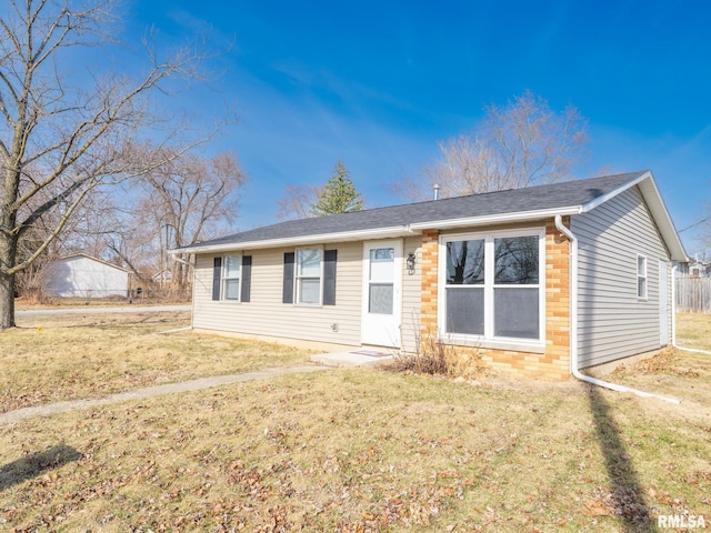 view of front of home with a front lawn and brick siding