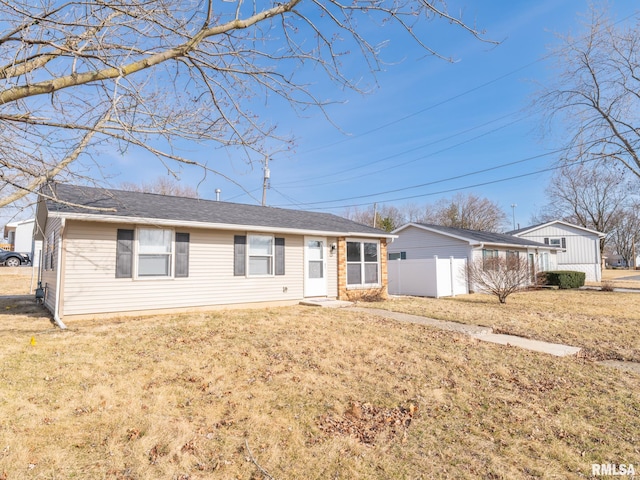 single story home with a front lawn and fence