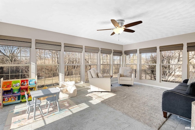 sunroom featuring ceiling fan