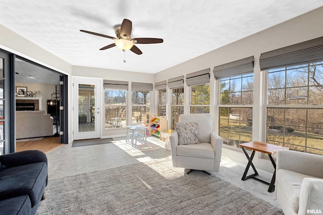 sunroom featuring a wealth of natural light and ceiling fan