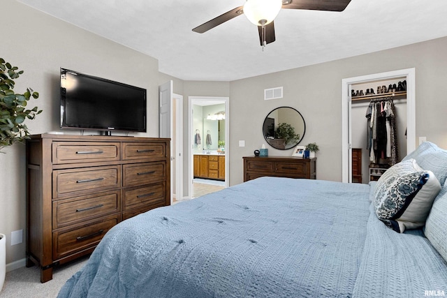 bedroom with visible vents, connected bathroom, baseboards, light colored carpet, and a ceiling fan