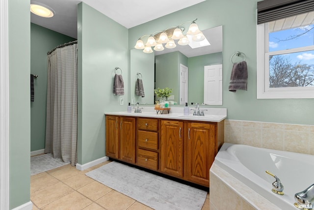 bathroom featuring baseboards, a garden tub, double vanity, tile patterned floors, and a sink