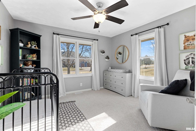 carpeted bedroom featuring a ceiling fan and baseboards