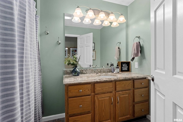 full bathroom featuring vanity, a shower with shower curtain, and baseboards